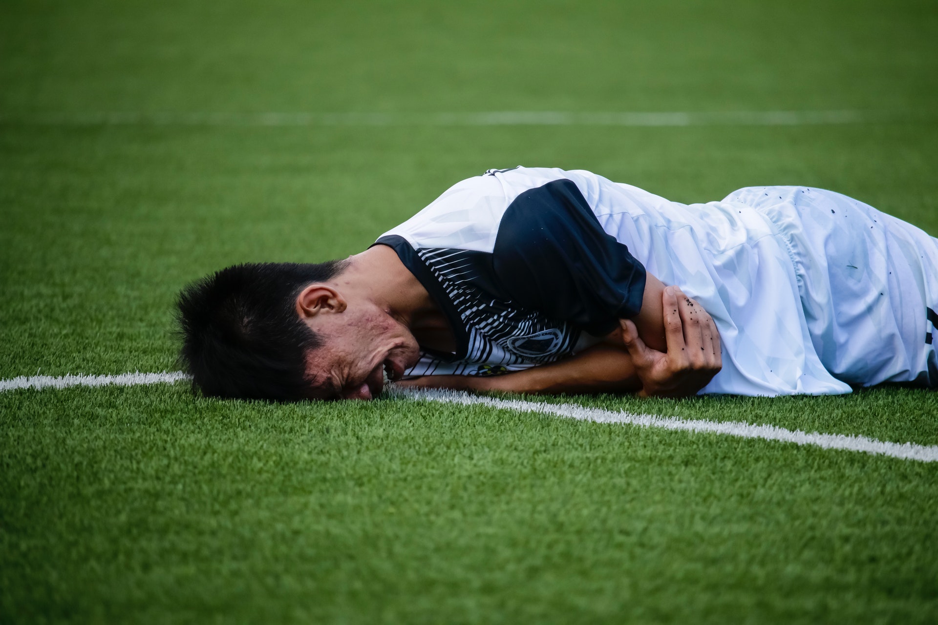 Crying man on soccer pitch